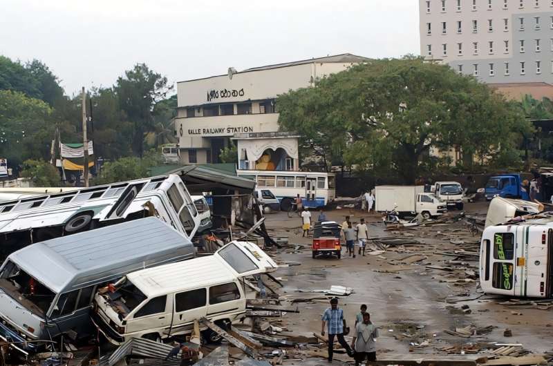 A combination photo shows vehicles damaged in the December 26, 2004 tsunami around the main bus terminal in Sri Lanka's Galle city on December 27, 2004 and buses at the same terminal on December 1, 2024. A combination photo shows vehicles damaged in the December 26, 2004 tsunami around the main bus terminal in Sri Lanka's Galle city on December 27, 2004 and buses at the same terminal on December 1, 2024.
