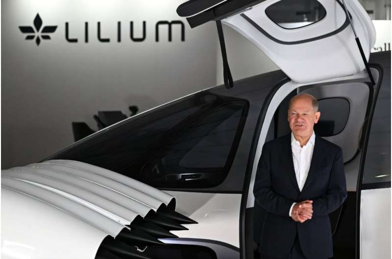 German Chancellor Olaf Scholz with a Lilium jet at an aerospace exhibition. German Chancellor Olaf Scholz with a Lilium jet at an aerospace exhibition